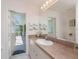 Bathroom sink with access to lanai through glass panel door at 4 Pine Valley Ln, Rotonda West, FL 33947