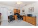 Bedroom features a wooden desk with office decor and a ceiling fan at 4 Pine Valley Ln, Rotonda West, FL 33947