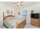 Bedroom with neutral tones, ceiling fan, and natural wood furniture at 4 Pine Valley Ln, Rotonda West, FL 33947