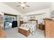 Bedroom with Beach House decor, ceiling fan, and lanai access at 4 Pine Valley Ln, Rotonda West, FL 33947