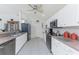 Modern kitchen equipped with stainless steel appliances, white cabinetry, and ample countertop space for meal preparation at 4 Pine Valley Ln, Rotonda West, FL 33947