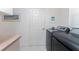 Modern laundry room featuring front-load washer and dryer, and counter space at 4 Pine Valley Ln, Rotonda West, FL 33947