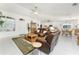 Spacious living room features neutral tile flooring, comfortable leather seating, and plenty of natural light at 4 Pine Valley Ln, Rotonda West, FL 33947