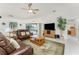 The living room includes plush seating, a ceiling fan, and lots of natural light, making it a comfortable and inviting space at 4 Pine Valley Ln, Rotonda West, FL 33947