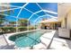 The caged-in pool is a perfect oasis and the yard is surrounded by privacy hedges to provide seclusion at 4 Pine Valley Ln, Rotonda West, FL 33947