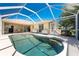 Beautiful screened-in pool with sparkling water, surrounded by a spacious patio area, perfect for entertaining and relaxing at 4 Pine Valley Ln, Rotonda West, FL 33947