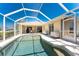 Inviting screened-in pool with sparkling water and a spacious patio, great for enjoying the outdoors and entertaining guests at 4 Pine Valley Ln, Rotonda West, FL 33947