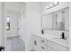 Stylish bathroom with double vanity, modern fixtures, and wood-look tile flooring at 40 Golfview Ct, Rotonda West, FL 33947