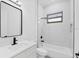 Contemporary bathroom showcasing sleek fixtures and a glass-enclosed shower/tub combo at 40 Golfview Ct, Rotonda West, FL 33947