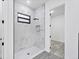 Clean and modern shower featuring tile walls, a rainfall showerhead, and a glass door at 40 Golfview Ct, Rotonda West, FL 33947
