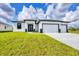 Beautiful new construction home with a three car garage and a well manicured lawn at 40 Golfview Ct, Rotonda West, FL 33947