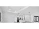 Spacious, bright living room with modern lighting and neutral tones, flowing into the kitchen at 40 Golfview Ct, Rotonda West, FL 33947