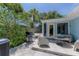 Cozy back patio with grill, seating area, and lush landscaping offers a tranquil outdoor space at 4065 N Beach Rd # A, Englewood, FL 34223