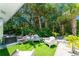 A backyard featuring artificial turf, white gravel, and tropical landscaping at 4065 N Beach Rd # A, Englewood, FL 34223