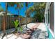 Side yard with a brick walkway, white gravel, and lush tropical landscaping and greenery at 4065 N Beach Rd # A, Englewood, FL 34223