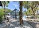 The backyard features gravel, stepping stones, a kayak, and lush tropical landscaping at 4065 N Beach Rd # A, Englewood, FL 34223