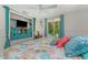Cozy bedroom with a ceiling fan, decorative bedding, and access to the outdoors at 4065 N Beach Rd # A, Englewood, FL 34223