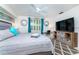 Comfortable bedroom featuring a ceiling fan, stylish decor, and a dedicated workspace at 4065 N Beach Rd # A, Englewood, FL 34223