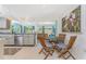 Open-concept dining area showcasing a wooden table and chairs, adjacent to a well-equipped kitchen at 4065 N Beach Rd # A, Englewood, FL 34223