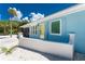 Charming exterior of the home shows the landscaping, curb appeal, and blue paint at 4065 N Beach Rd # A, Englewood, FL 34223