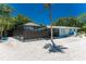 Exterior view of a blue home with a screened-in porch and pool area at 4065 N Beach Rd # A, Englewood, FL 34223