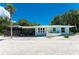 Charming blue single-story home with a screened-in porch and well-kept landscaping at 4065 N Beach Rd # A, Englewood, FL 34223