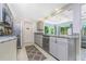 Modern kitchen featuring stainless steel appliances and granite countertops, with a view to the living room at 4065 N Beach Rd # A, Englewood, FL 34223