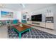 Inviting living room featuring a comfortable gray couch, modern TV, and patterned rug at 4065 N Beach Rd # A, Englewood, FL 34223