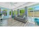 Bright sunroom features a cozy living space with plenty of natural light at 4065 N Beach Rd # A, Englewood, FL 34223