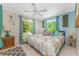 Bright and airy main bedroom with a sliding glass door, stylish decor, and a cozy queen bed at 4065 N Beach Rd # A, Englewood, FL 34223
