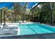 Screened-in pool with spa offers relaxation and recreation in a private, landscaped setting at 4065 N Beach Rd # A, Englewood, FL 34223