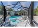 Screened-in pool with spa and lounge chairs, perfect for relaxing and entertaining outdoors at 4065 N Beach Rd # A, Englewood, FL 34223