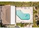 Aerial view of a community pool featuring clear water, lounge chairs, shaded areas and green landscaping at 4207 Fairway Pl, North Port, FL 34287