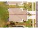 Aerial view of property showing the roof, driveway, landscaping, and proximity to neighboring homes and foliage at 4207 Fairway Pl, North Port, FL 34287
