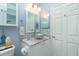 The stylish bathroom features a vessel sink, framed mirror, and vanity with ornate hardware, offering a blend of functionality and design at 4207 Fairway Pl, North Port, FL 34287