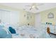 Cozy bedroom featuring a bed with a patterned comforter, closet, and ample natural light at 4207 Fairway Pl, North Port, FL 34287