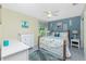 Bright bedroom featuring coastal accents, a desk area, white furniture, and stylish decor at 4207 Fairway Pl, North Port, FL 34287