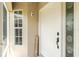 Inviting entryway with a white door, decorative glass, window, and 'WELCOME' sign at 4207 Fairway Pl, North Port, FL 34287