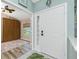 Foyer entrance with a decorative glass door leading to a bedroom with a vaulted ceiling at 4207 Fairway Pl, North Port, FL 34287