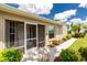 Inviting screened front entry and front yard landscaping including mulch and flowering shrubbery at 4207 Fairway Pl, North Port, FL 34287