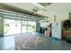 Spacious garage with an open door, offering ample room for parking and storage solutions, including a refrigerator and shelving at 4207 Fairway Pl, North Port, FL 34287