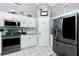 This kitchen has white cabinets, stainless steel appliances, tile backsplash, and a pantry at 4207 Fairway Pl, North Port, FL 34287