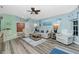 Spacious living room with hardwood floors, comfortable seating, and abundant natural light at 4207 Fairway Pl, North Port, FL 34287