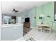 Open concept living space with wood floors, dining area, ceiling fan, and sliding doors leading to the lanai at 4207 Fairway Pl, North Port, FL 34287