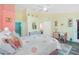 Bright bedroom with coastal decor, ceiling fan, dresser, and desk area, complete with ensuite bathroom access at 4207 Fairway Pl, North Port, FL 34287