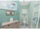 Charming powder room featuring a custom cabinet, toilet, nautical decor, and modern fixtures at 4207 Fairway Pl, North Port, FL 34287