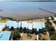 Beautiful aerial view of condos, surrounding landscape, and scenic waterfront with a long pier at 4410 Warren Ave # 104, Port Charlotte, FL 33953