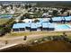 Aerial view of condo complex showing landscaping, community pool, and surrounding area at 4410 Warren Ave # 104, Port Charlotte, FL 33953