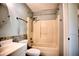 Bathroom featuring a shower and tub combination, updated fixtures, and ceramic tile details at 4410 Warren Ave # 104, Port Charlotte, FL 33953