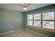 Cozy bedroom featuring a ceiling fan, window with blinds, and light green painted walls at 4410 Warren Ave # 104, Port Charlotte, FL 33953